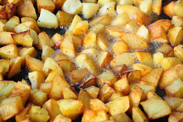 Potato pieces being fried in oil