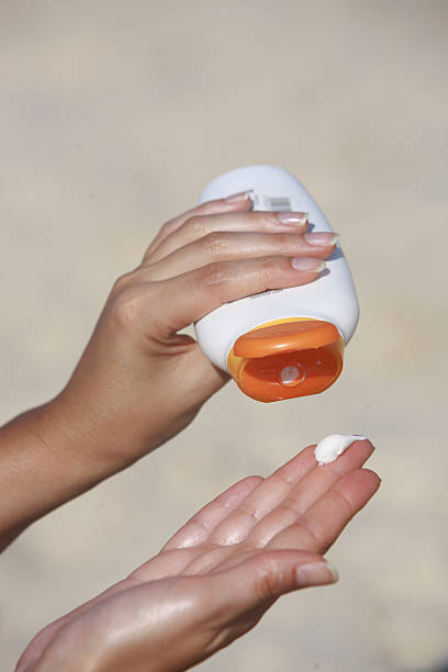 istock woman hands suntan cream protection 95520739