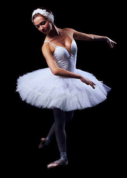 The girl in a ballet suit on black background stock photo