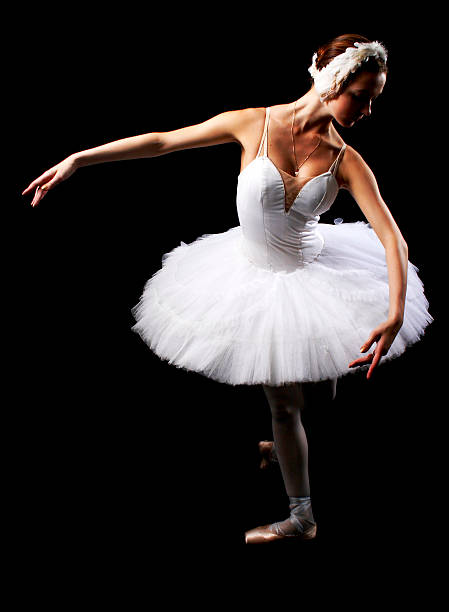 The girl in a ballet suit on black background stock photo