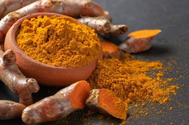 istock turmeric powder on black table, spices and herb concept 955230584
