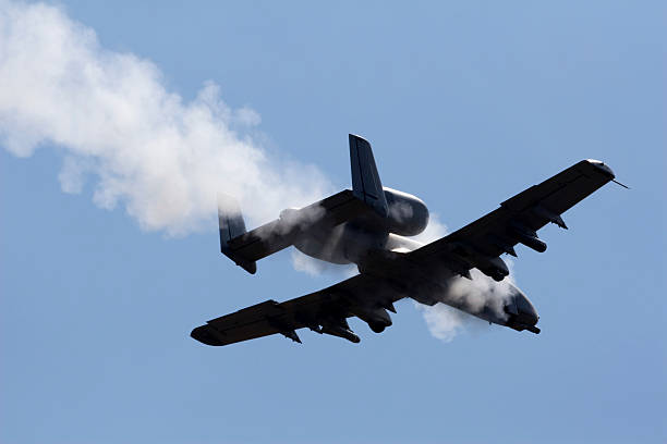 Tank Killer A military aircraft fires its gun on a target. a10 warthog stock pictures, royalty-free photos & images