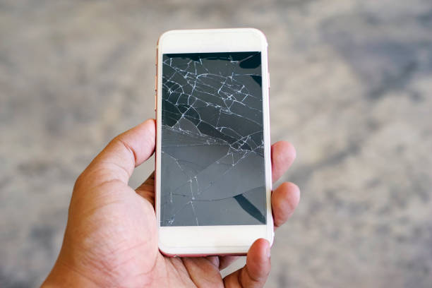 istock Businessman holding a crack smartphone. Shallow DOF. 955237152