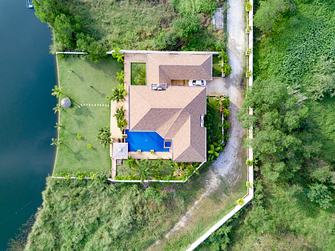 Top View Beautiful Garden Villa Resort, Above the Holiday Villa with swimming Pool on the lake with green garden. Aerial Drone Top View Top View Village scenic Landscape.