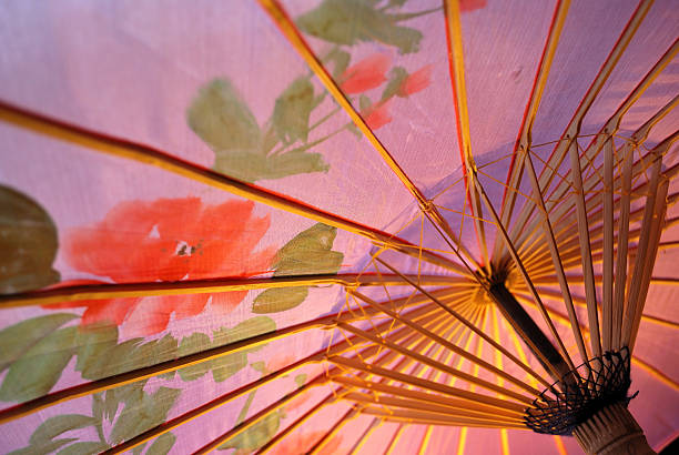 Golden beach umbrella isolated on white background. 3d render