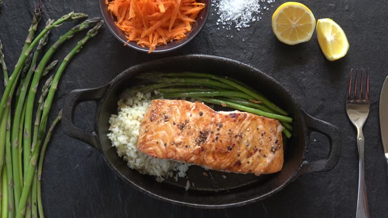 Healthy eating with trendy cauliflower rice for healthy omega rich diet. Prepared and served in a rustic cast iron skillet.