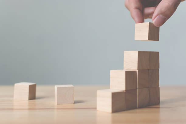 istock Hand arranging wood block stacking as step stair. Ladder career path concept for business growth success process, Copy space 955248340
