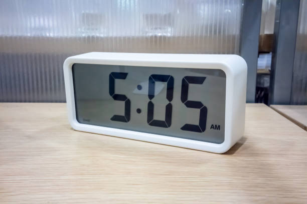 istock White pocket digital clock on wooden shelf for decoration 955251282
