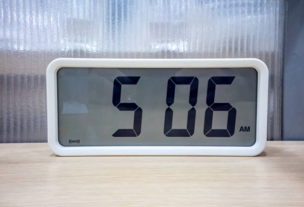 istock White pocket digital clock on wooden shelf for decoration 955251284