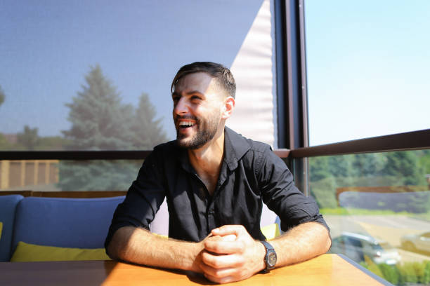 istock Male ecologist sitting at office on sofa with trees in background 955255672