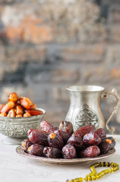 istock Various of dried dates or kurma in a vintage plates. 955257142