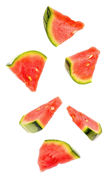 istock sliced flying watermelon isolated on white background. cut watermelon in pieces isolated on white background. Levity fruit floating in the air. 955257184