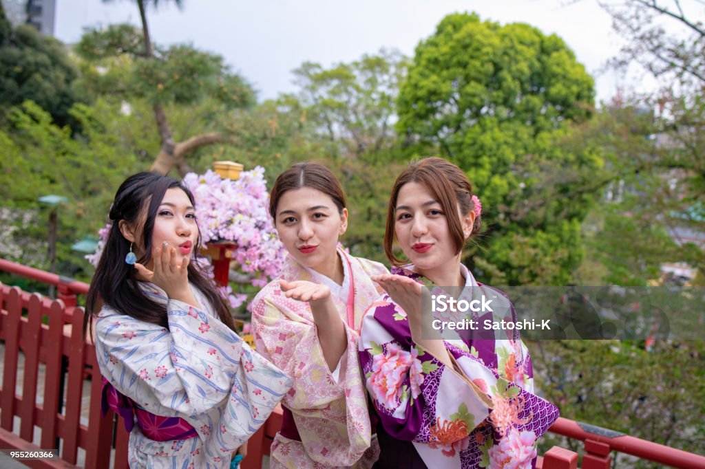Young women in kimono blowing kisses Japanese Ethnicity Stock Photo