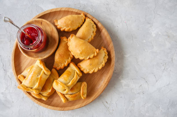 istock Two types of empanadas on a wooden plate with ketchup 955263852