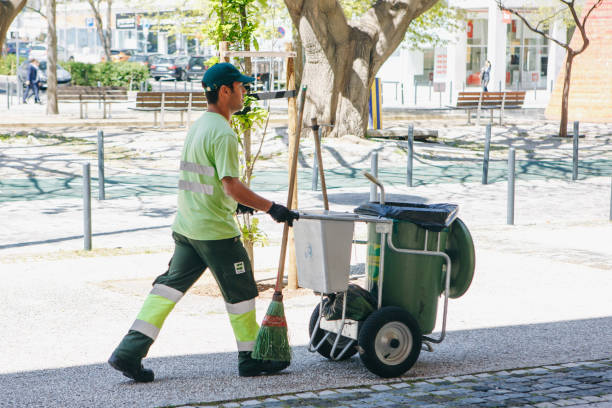 A professional cleaner works on a city street. Cleaning the territory and taking care of ecological well-being. stock photo