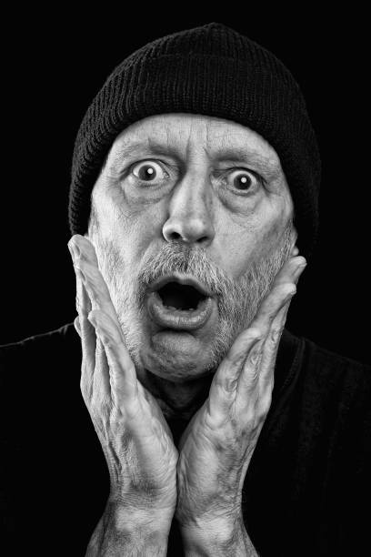istock Surprised strong man with a beard and a woolen cap 955268040