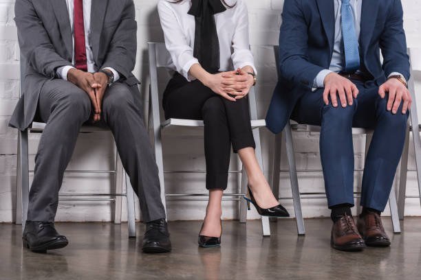 istock partial view of multiethnic business people sitting on chairs while waiting for job interview 955268602