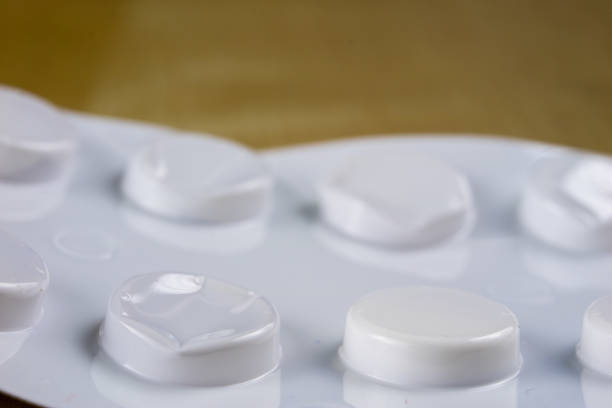 A white pill bottle with a white pill inside. High quality photo