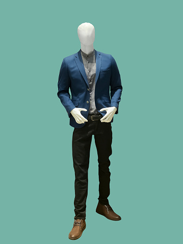 Full-length male mannequin dressed in casual clothes, isolated on green background. No brand names or copyright objects.