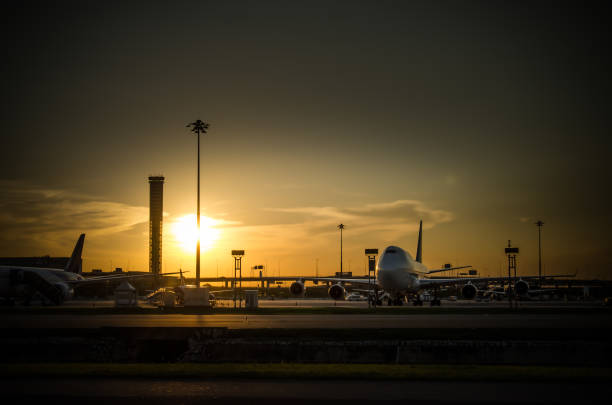 istock Airport airliner at dusk departure with control tower 955282482