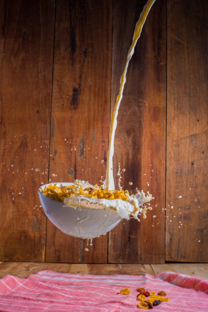 Corn flake bowl and pouring milk levitate in mid air
