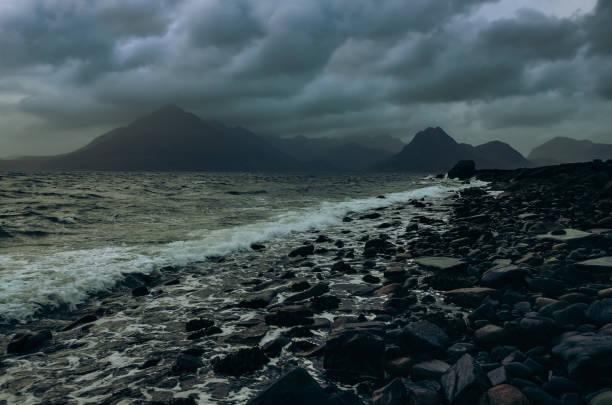 Dramatic landscape coastline view of rocks and Cullin hills, Scotland Dramatic landscape coastline view of rocks and Cullin hills, Scotland, United Kingdom elgol beach stock pictures, royalty-free photos & images