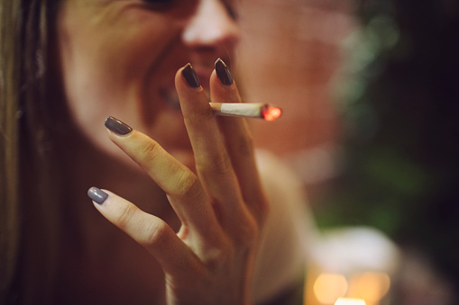 Blond woman smoking cigarette.