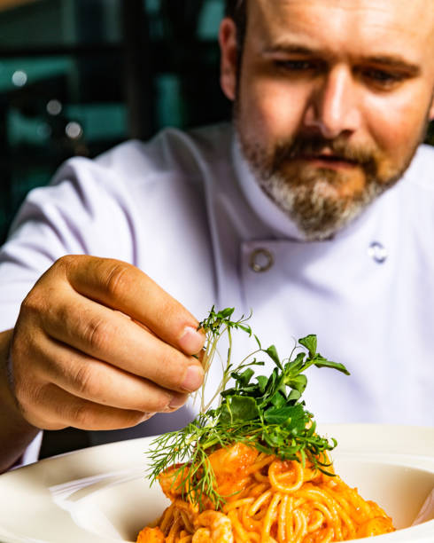 istock Chef Styling Plate of Spaghetti With Seafood and Microgreens 955306404