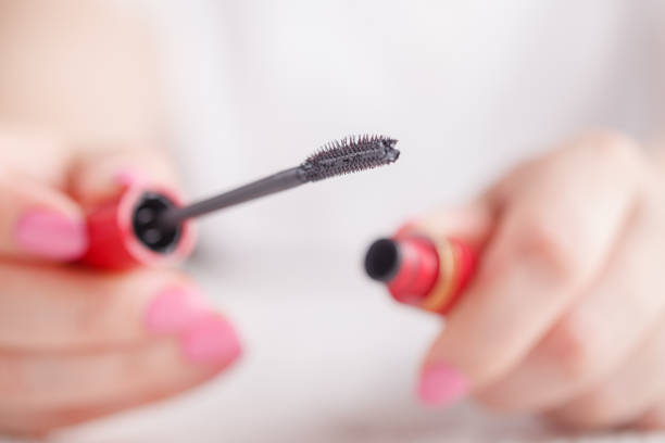 istock Eyelash makeup brush and mascara bottle close up 955312810