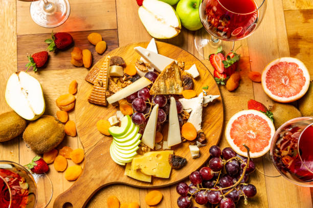 istock Cheese board with fruits and wine 955312948