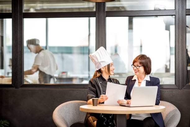 Senior chef and young cook at the restaurant