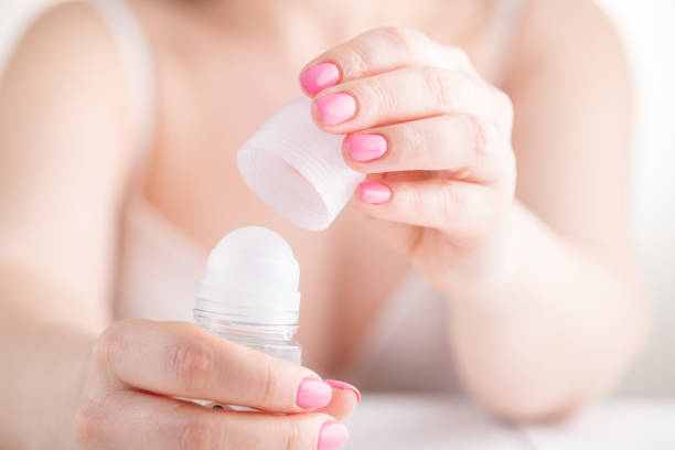 istock Female hand with antiperspirant bottle 955331956