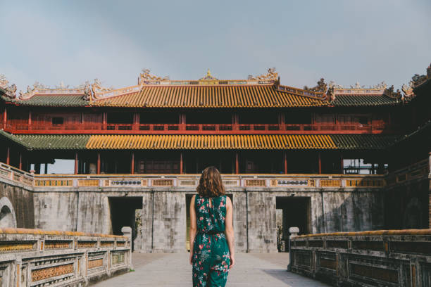 istock Woman walking in Hue Forbidden city 955332078
