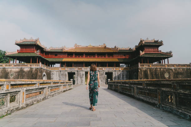 istock Woman walking in Hue Forbidden city 955332084