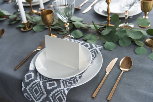 istock close up view of empty card on plates on tabletop with beautiful rustic setting for guests 955337542