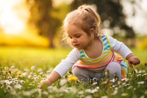 istock Girl playing on flower field 955342068