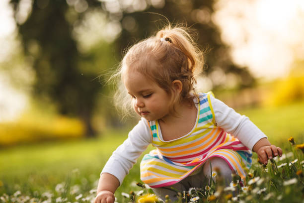 istock Girl playing on flower field 955342070