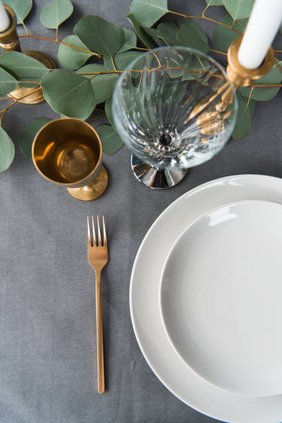 istock top view of rustic table setting with eucalyptus, old fashioned cutlery, candles in candle holder and empty plates 955342816