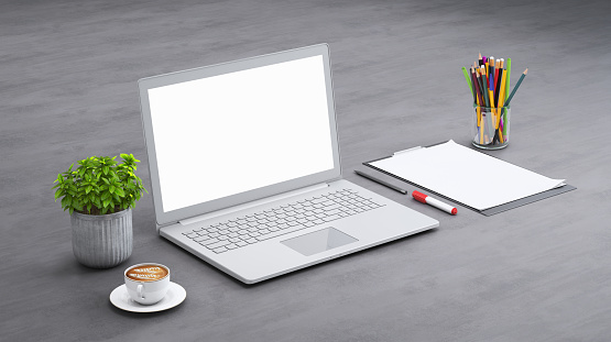 Isometric mock up with large open laptop with blank screen, paper, markers and a plant. Diagonal frame setup. Warm coffee. Modern designer background template. Coffee.