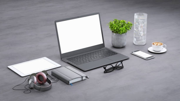 Isometric mock up with large open laptop with blank screen, tablet, glasses, headphones, paper, plant, markers and a plant. Diagonal frame setup. Modern designer background template.