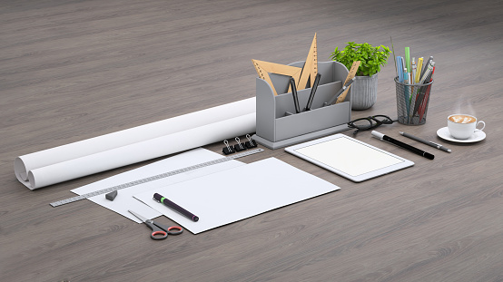 Diagonal composition, architect designer desk with papers, rulers, pencils and office accessories, warm coffee and blank digital tablet. Plant in a vase.  Mock up background template