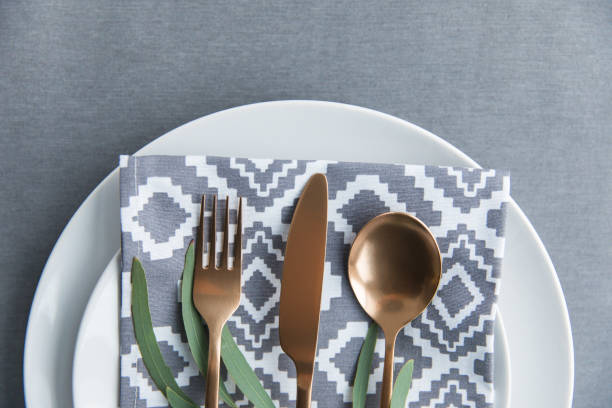 istock flat lay with rustic table setting with vintage tarnished silverware, napkin, green plant and plate 955347710