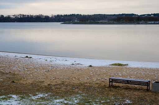 Sunset at a lake near Kaunas, Lithuania. Empty bench also on scene. Sunset.