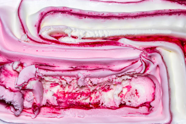 istock Background texture of swirling pink Italian ice cream with a ridged pattern in square format 955361160