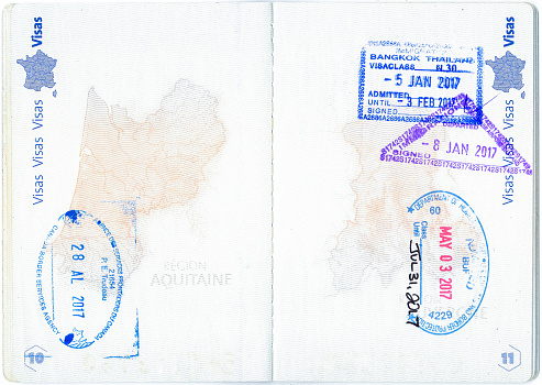 Stamps of Canada, United States and Thailand in a French passport. Personal data removed