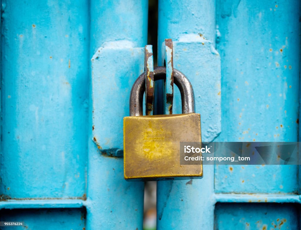 key lock old stitched in the blue door. Lock Stock Photo
