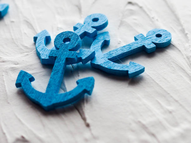 Background with decorative anchors and wheels on a white painted background. Place for text. Top view with copy space