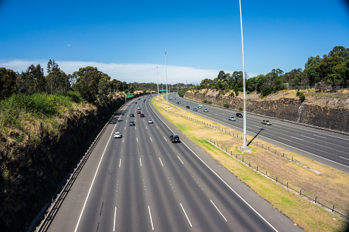 Melbourne, Australia - January 4, 2015: Traffic outbound on the Eastern Freeway during the day, approaching the Chandler Highway exit.
