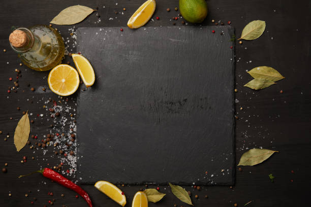 istock Dark slate board with spices and lemon slices 955388894