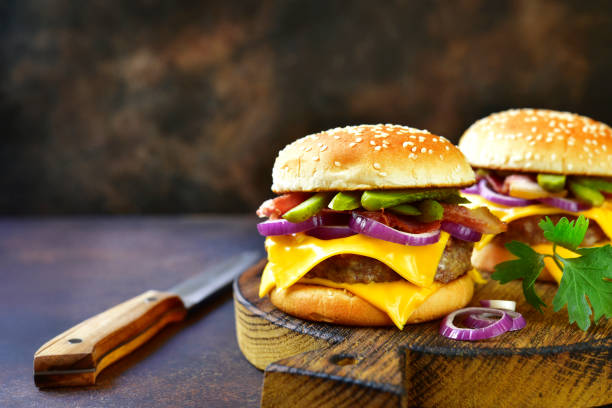 istock Cheeseburger with beef cutlet, fried bacon and pickled cucumber 955392972